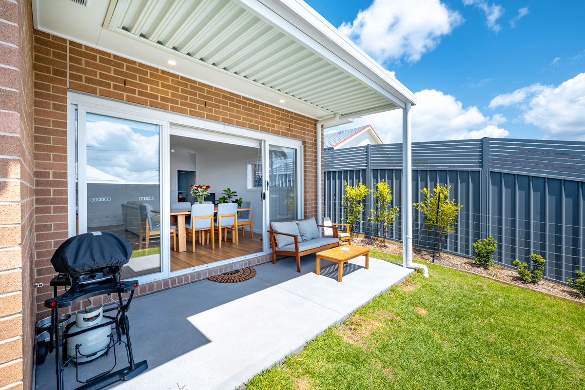 Spacious courtyard opening with large glass sliding doors to the living area